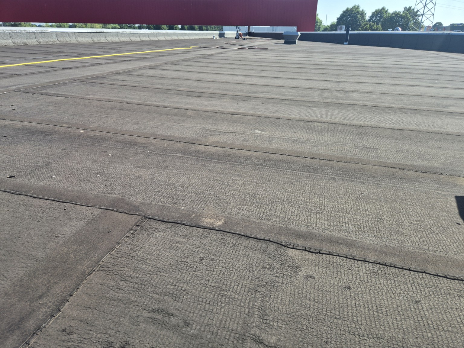 Verouderde bitumen dakbedekking bij dakcoating in weert: 350 m² bedrijfsdak gerenoveerd met 2k-polyurea
